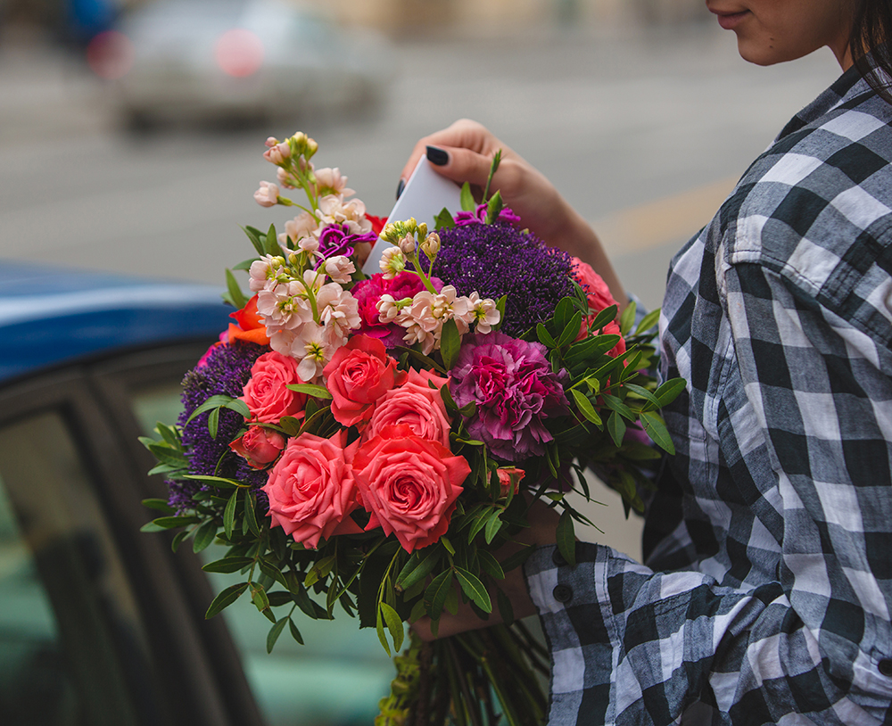 Same-day flower delivery in Dubai — courier handing bouquet to customer