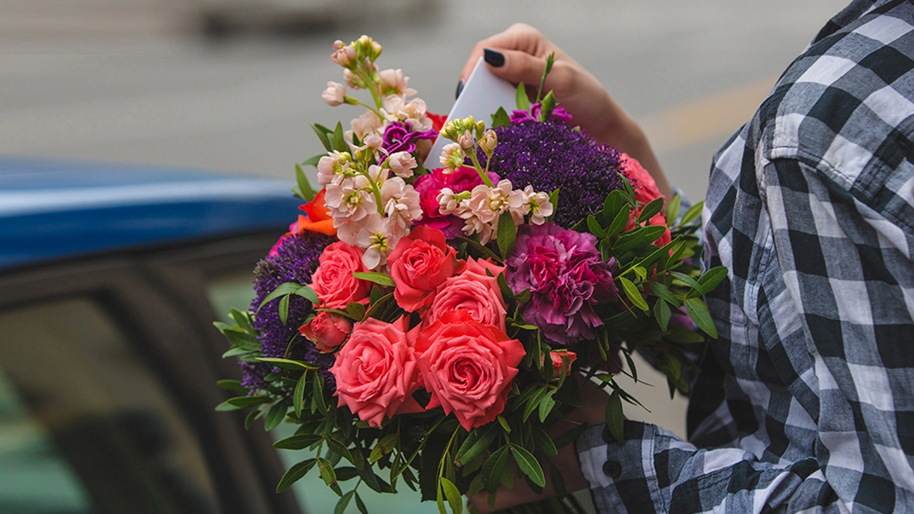 Same-day flower delivery in Dubai — courier handing bouquet to customer